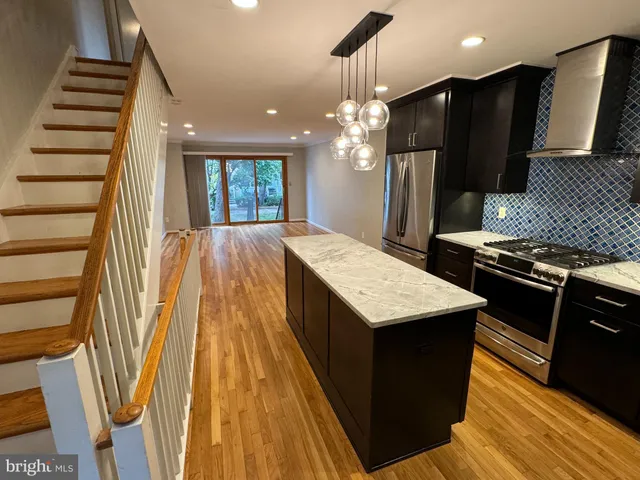 a kitchen with sink and refrigerator