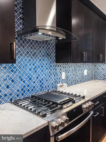 a stove sitting inside of a kitchen