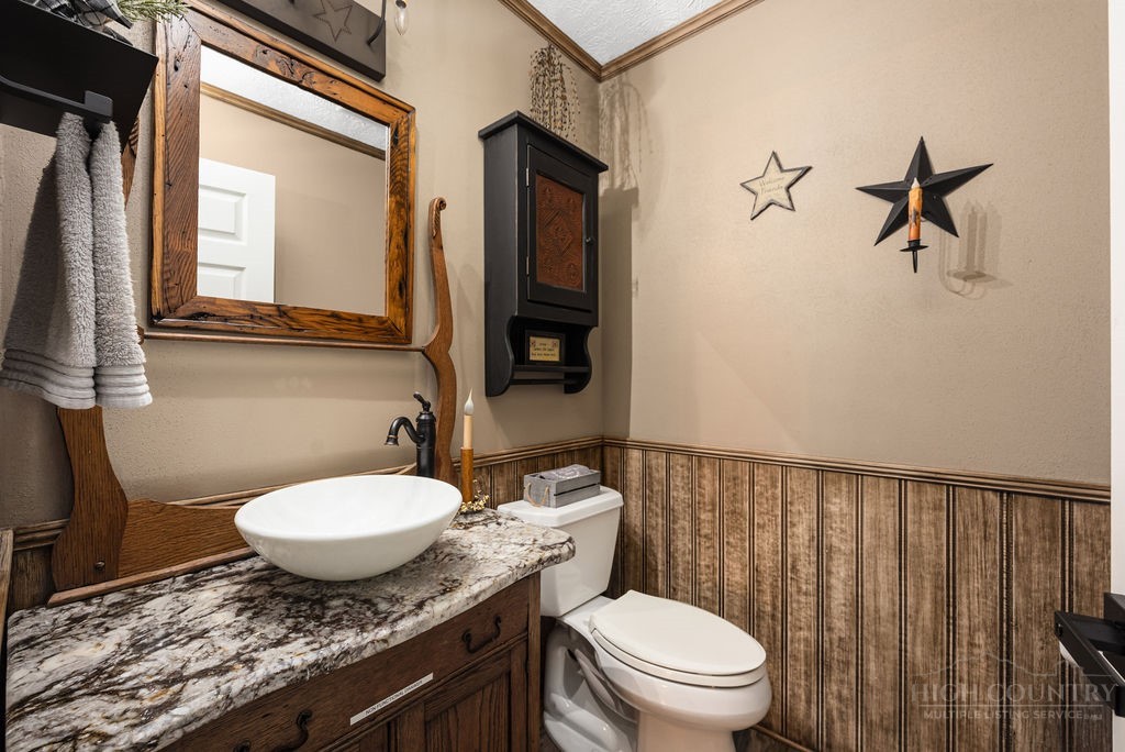 970 Vox Road Sparta, NC 28675 - Photo 25 of 50 a bathroom with a granite countertop toilet sink and mirror