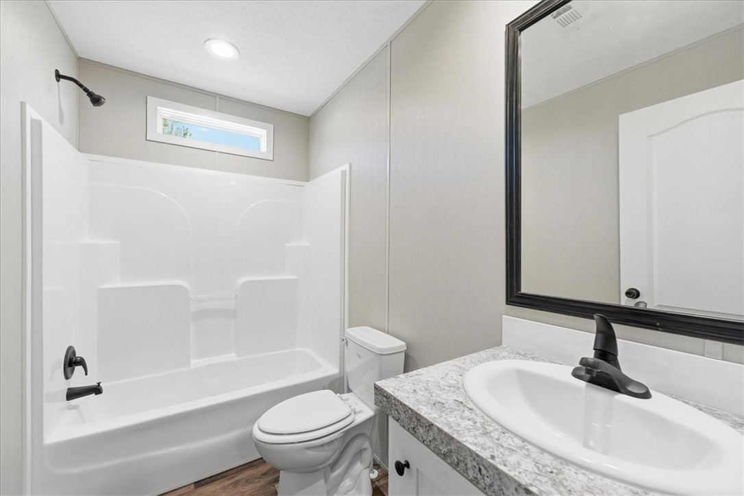 205 Union Court West Union, SC 29696 - Photo 22 of 28 This second full bathroom features a vanity, a bathtub, and a window for natural light.
