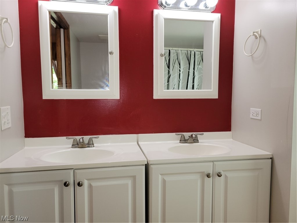 22922 Putney Ridge Road Quaker City, OH 43773 - Photo 26 of 31 Bathroom featuring mirror and dual vanity