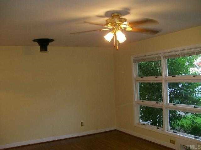 2912 Wade Avenue Raleigh, NC 27607 - Photo 3 of 11 wooden floor in an empty room with a window