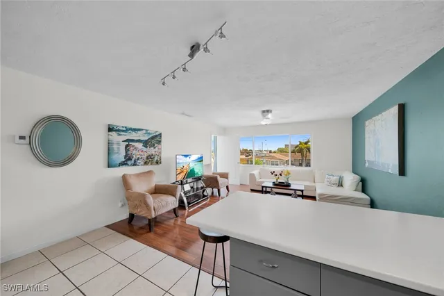 a kitchen with stainless steel appliances a table chairs and a refrigerator