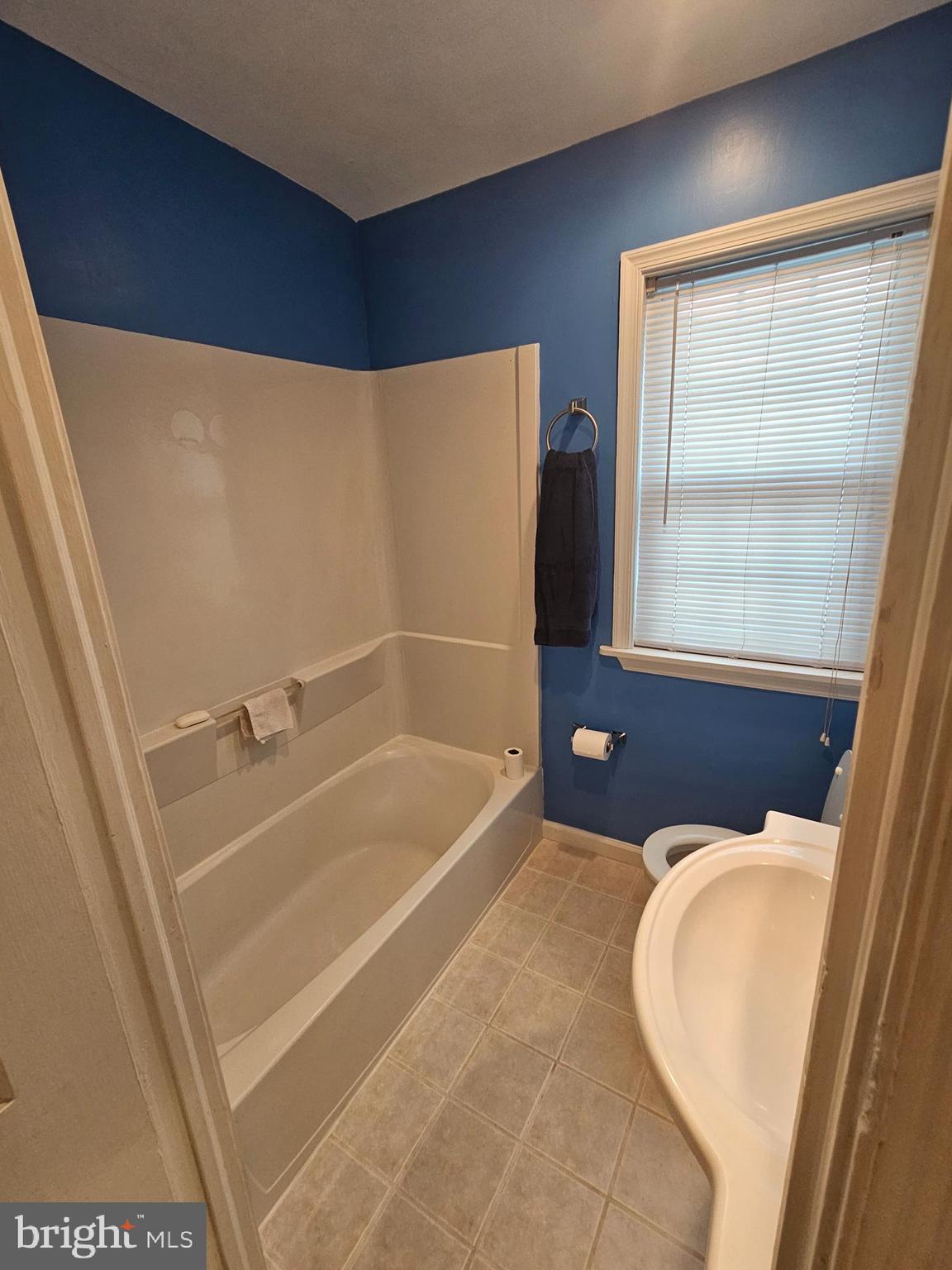 6907 Belclare Road Baltimore, MD 21222 - Photo 13 of 26 a bathroom with a bathtub and a shower