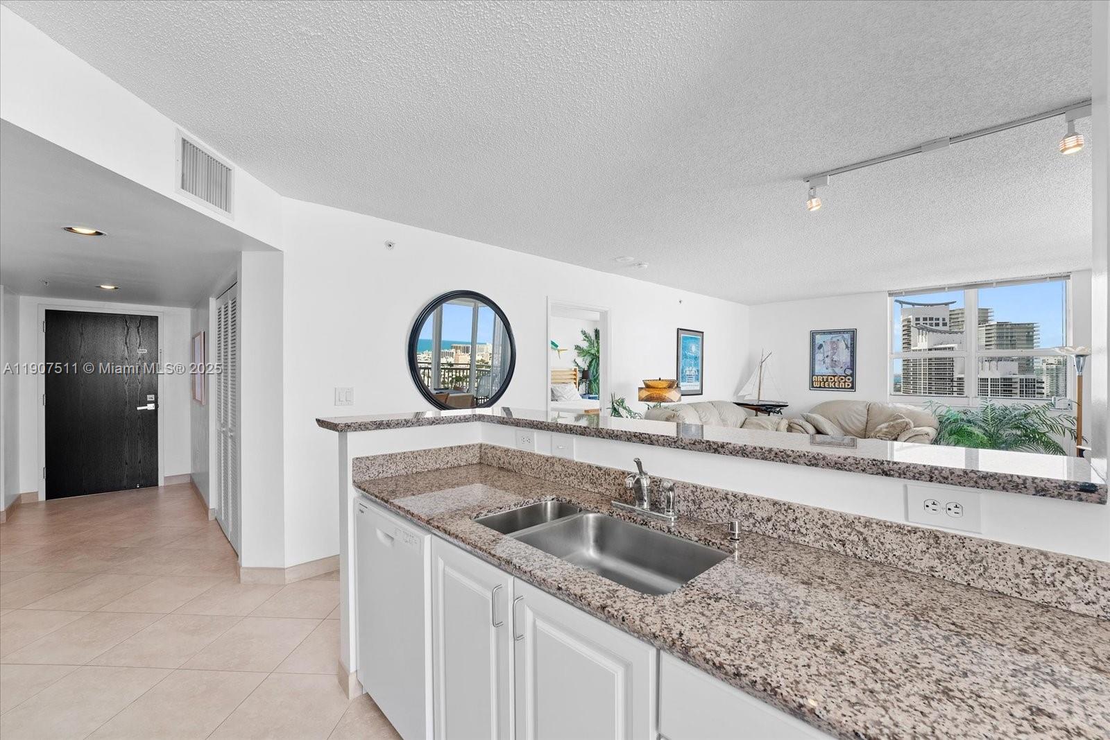 90 Alton Road, Unit 2911 Miami Beach, FL 33139 - Photo 11 of 39 a kitchen with a sink and a stove