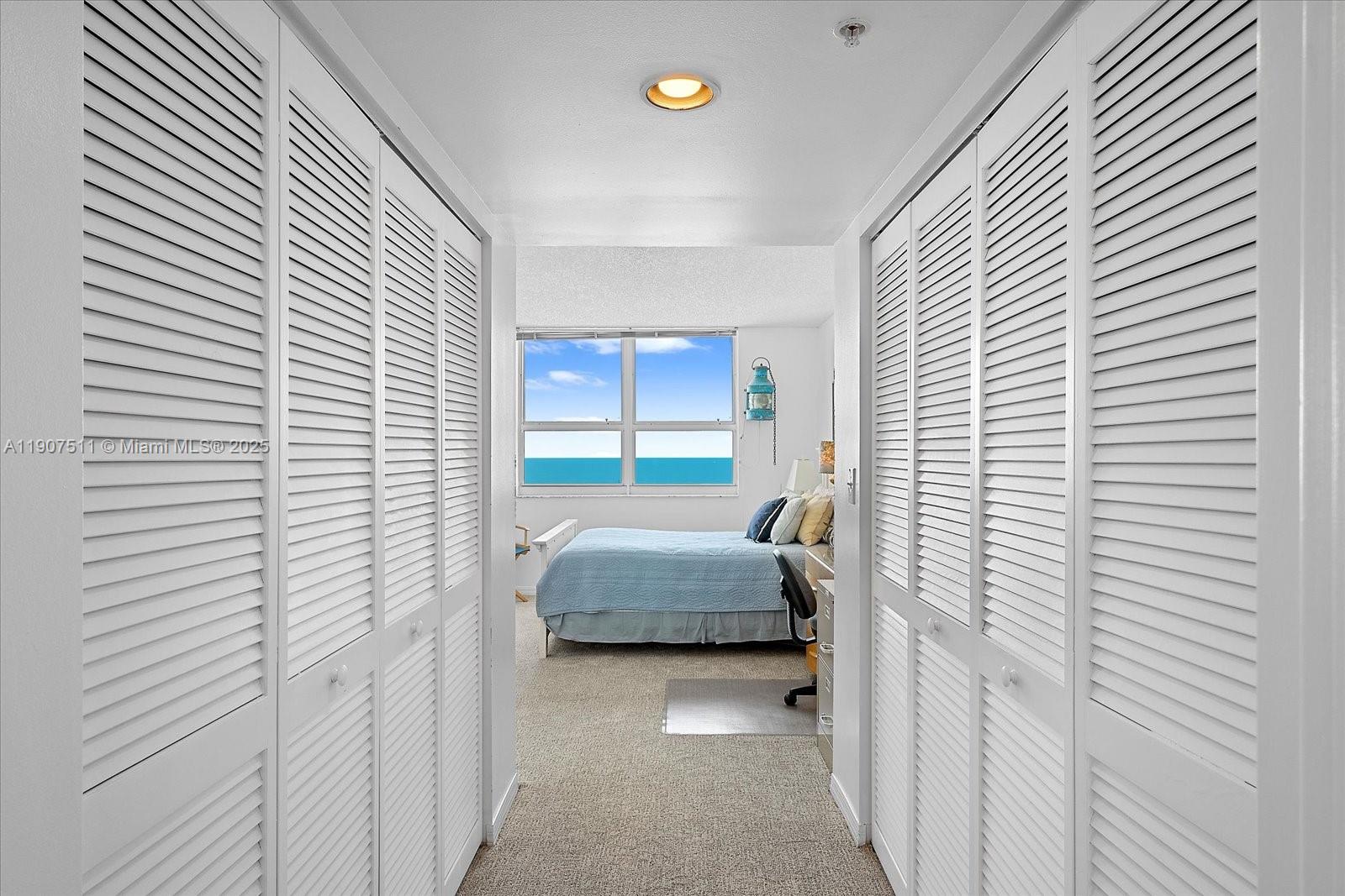 90 Alton Road, Unit 2911 Miami Beach, FL 33139 - Photo 18 of 39 a bedroom with a bed and a window