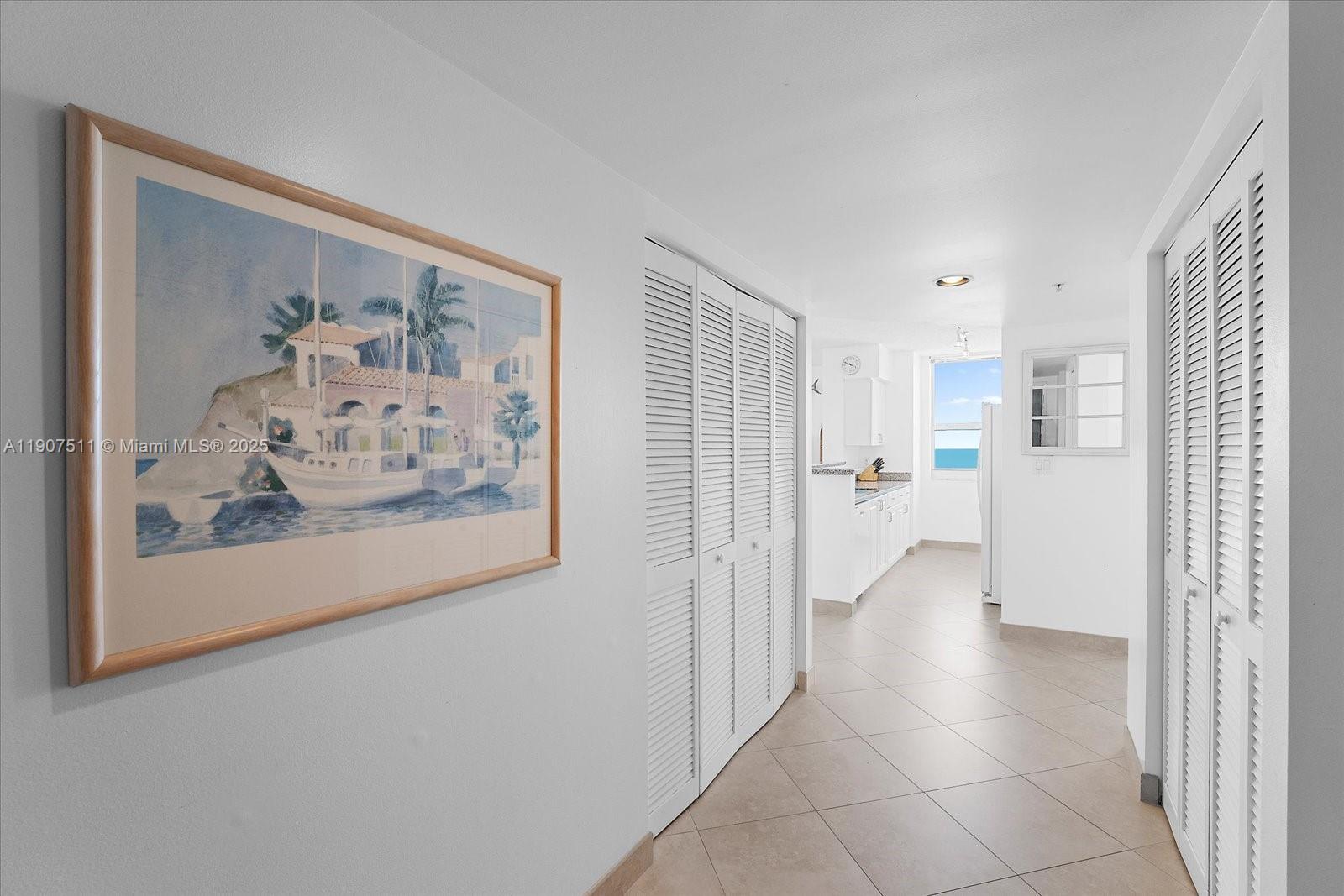 90 Alton Road, Unit 2911 Miami Beach, FL 33139 - Photo 19 of 39 a view of a hallway with a painting on the wall