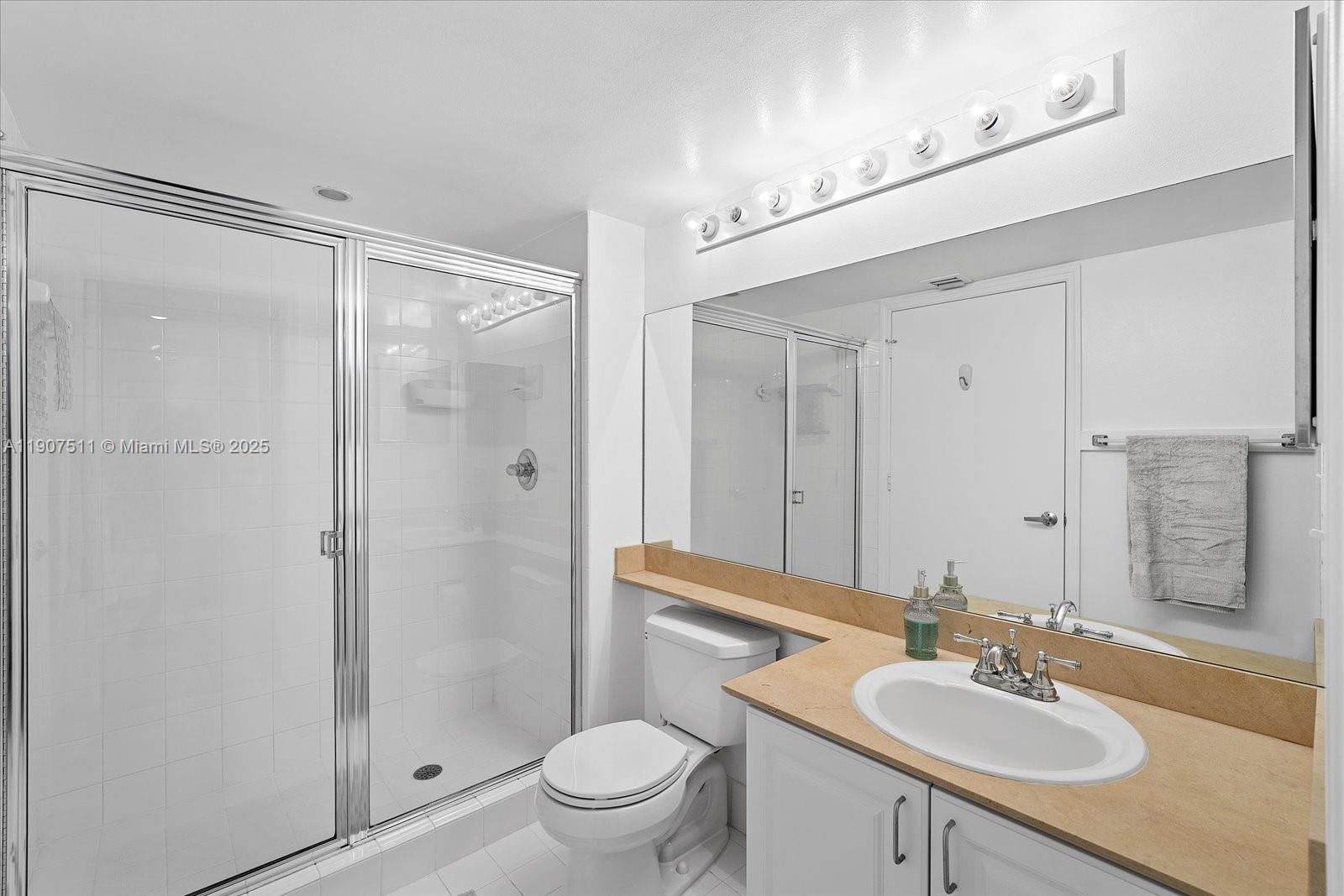 90 Alton Road, Unit 2911 Miami Beach, FL 33139 - Photo 22 of 39 a bathroom with a sink toilet and shower