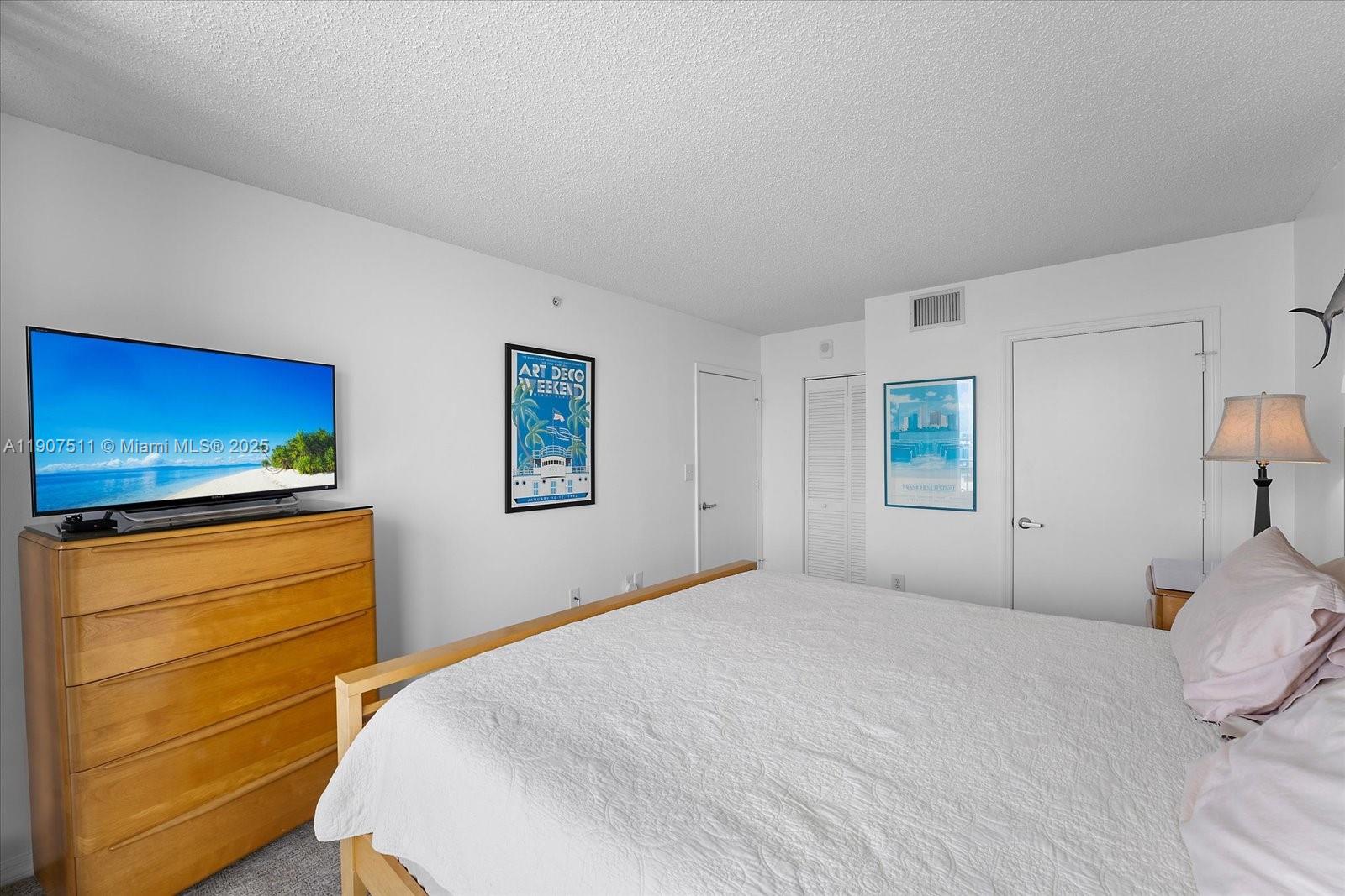 90 Alton Road, Unit 2911 Miami Beach, FL 33139 - Photo 23 of 39 a bedroom with a bed and a television