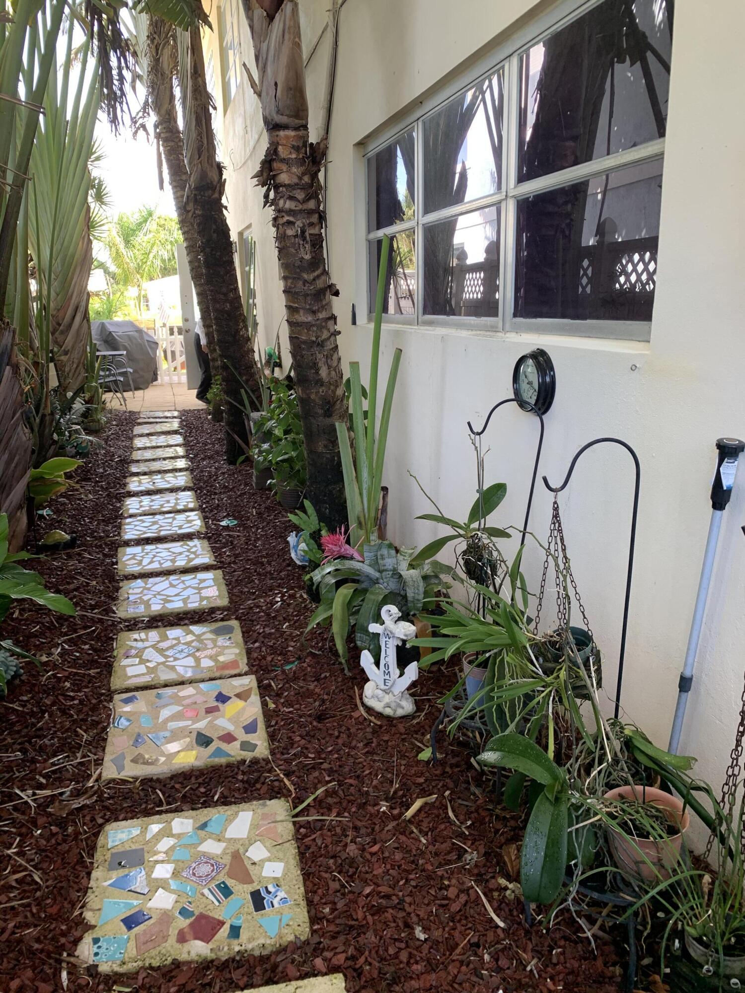 2735 Northeast 28th Court Lighthouse Point, FL 33064 - Photo 11 of 28 a vase of flowers sitting on a wooden floor