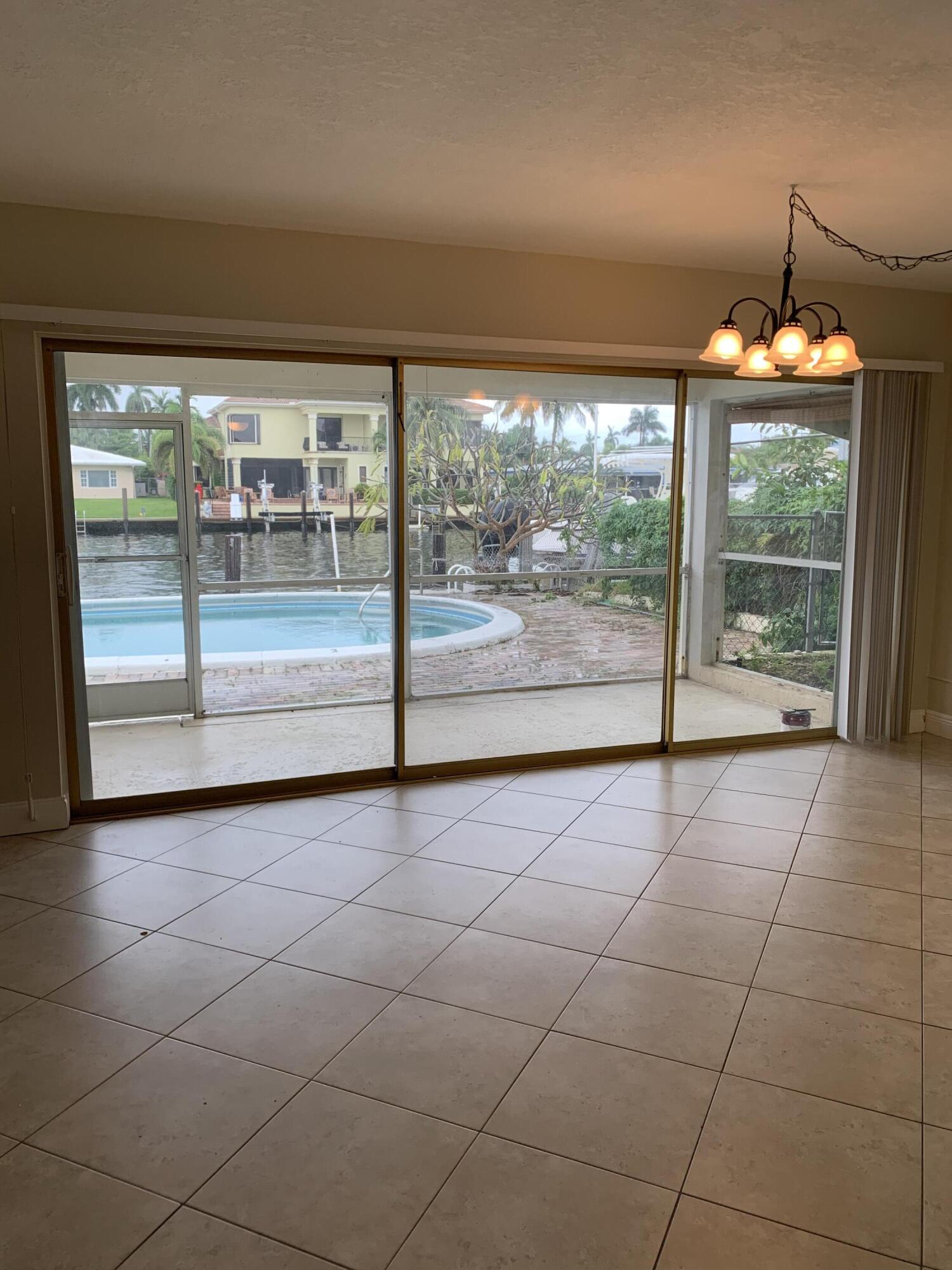 2735 Northeast 28th Court Lighthouse Point, FL 33064 - Photo 15 of 28 wooden floor in an empty room with a floor to ceiling window