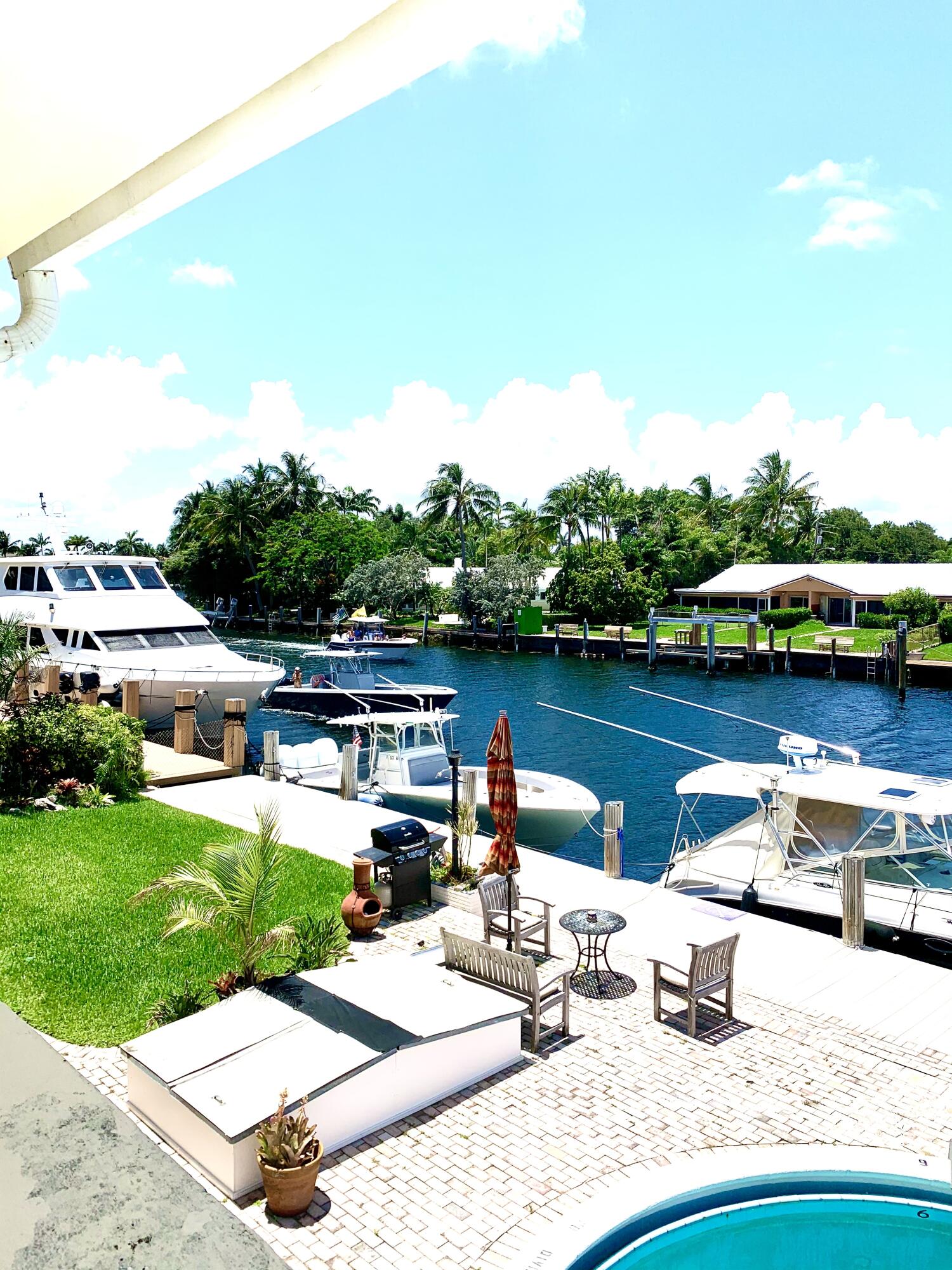 2735 Northeast 28th Court Lighthouse Point, FL 33064 - Photo 5 of 28 a view of a lake with couches and city view