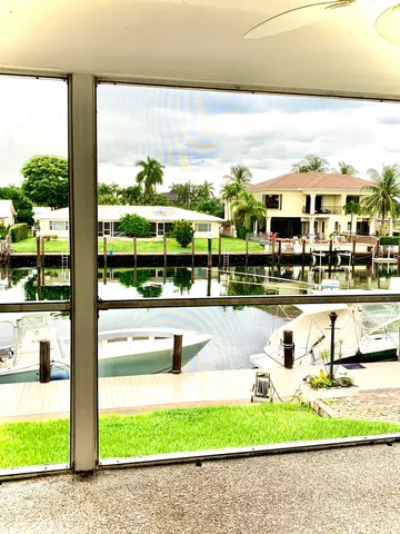 a view of a swimming pool with lawn chairs and a yard