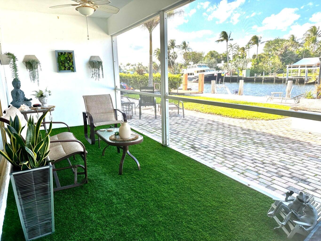 2735 Northeast 28th Court Lighthouse Point, FL 33064 - Photo 7 of 28 a view of a swimming pool with lawn chairs and a yard