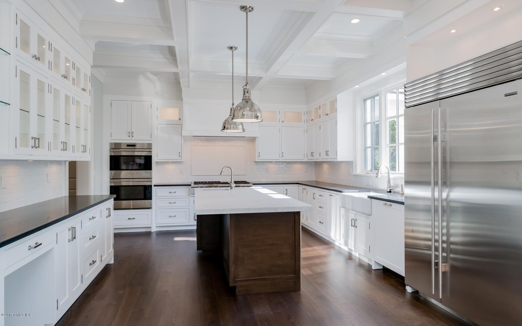 171 Cognewaugh Road Cos Cob, CT 06807 - Photo 12 of 31 a kitchen with stainless steel appliances kitchen island granite countertop a stove a sink and white cabinets with wooden floor