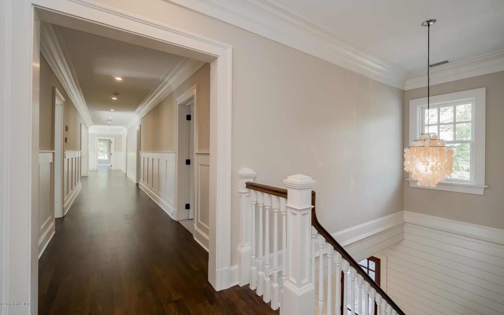 171 Cognewaugh Road Cos Cob, CT 06807 - Photo 19 of 31 a view of a hallway with wooden floor and stairs