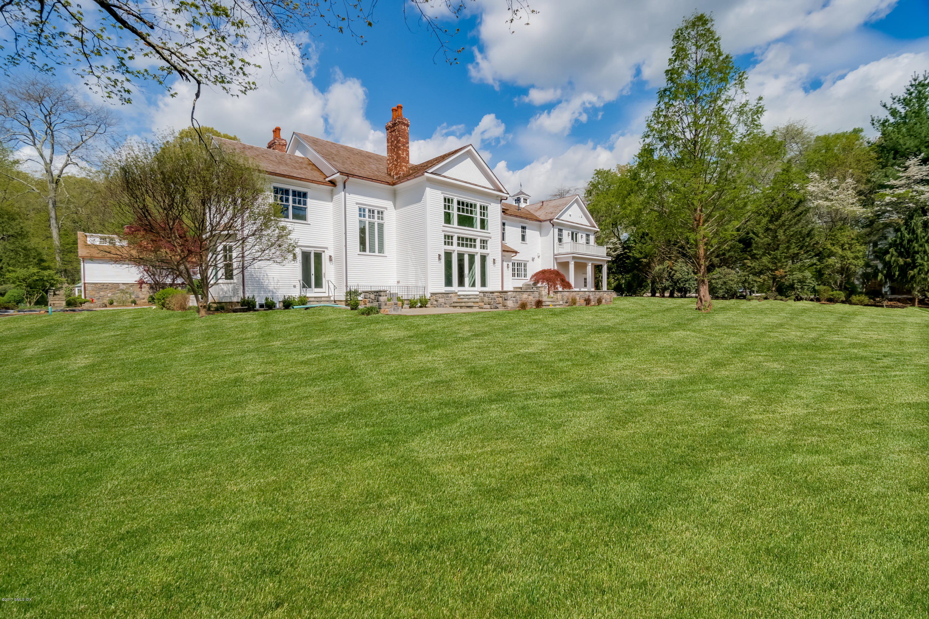 171 Cognewaugh Road Cos Cob, CT 06807 - Photo 29 of 31 a view of a house with a big yard and large trees