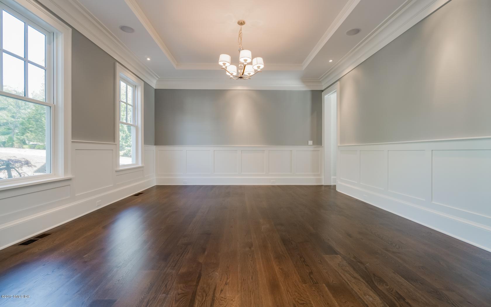171 Cognewaugh Road Cos Cob, CT 06807 - Photo 8 of 31 a view of an empty room with wooden floor and a window