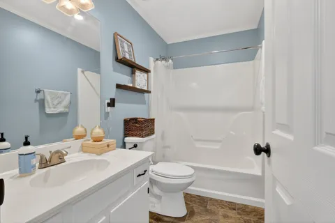 a bathroom with a sink toilet tub and shower
