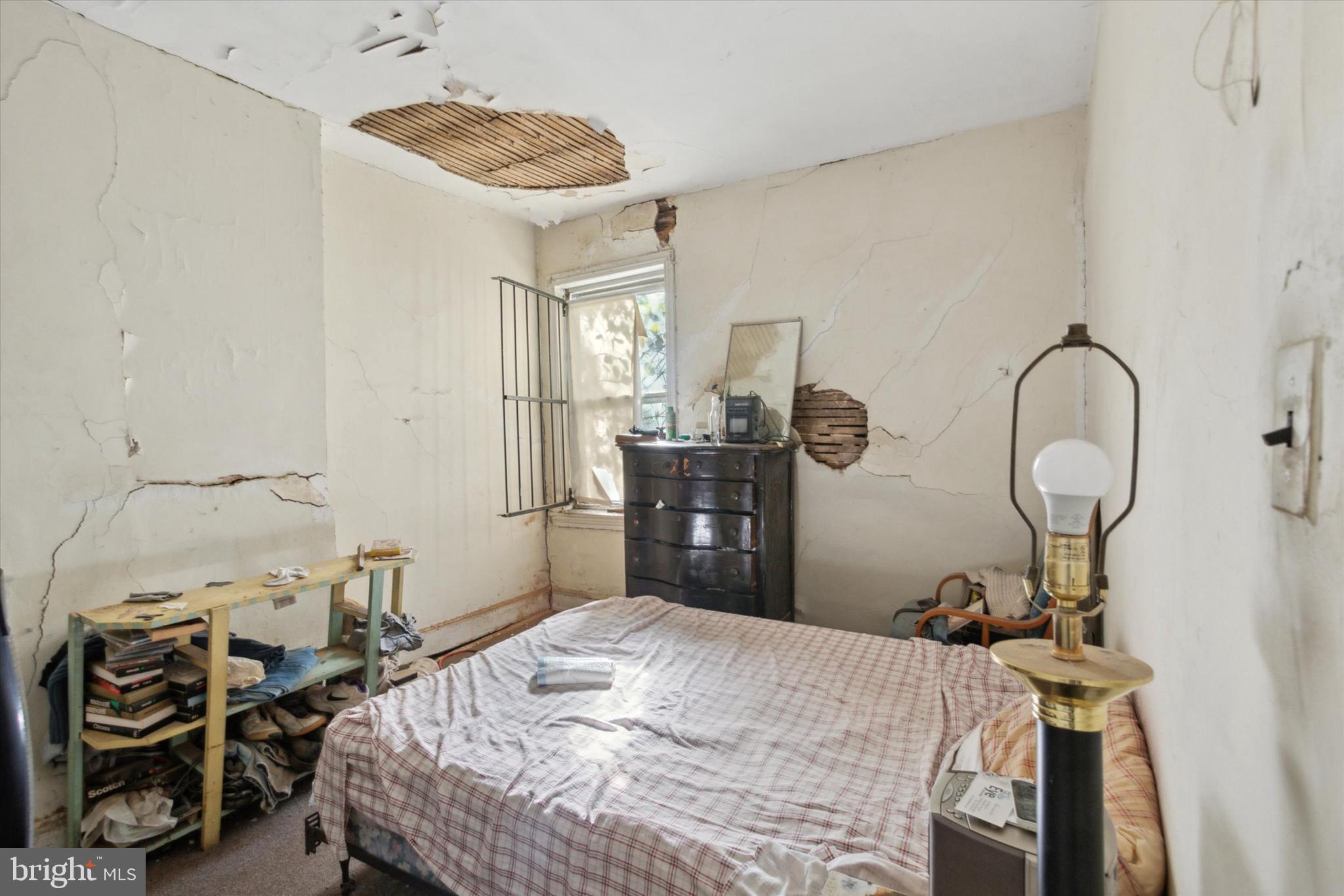 4800 Merion Avenue Philadelphia, PA 19131 - Photo 11 of 15 a bedroom with a bed and a chandelier