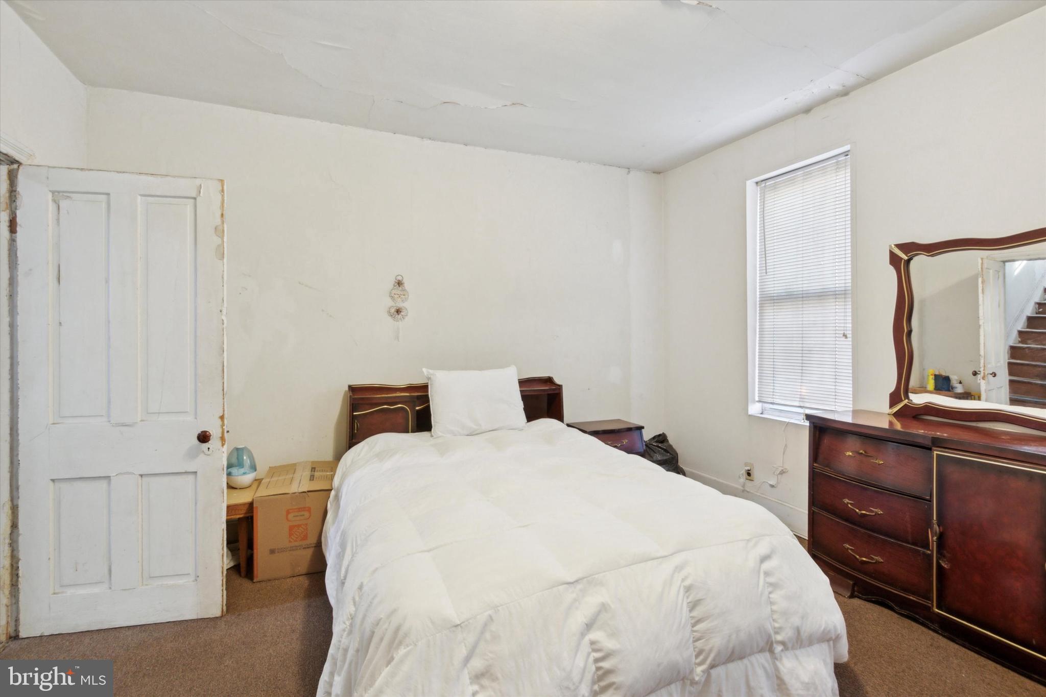 4800 Merion Avenue Philadelphia, PA 19131 - Photo 14 of 15 a bedroom with a bed and a large window