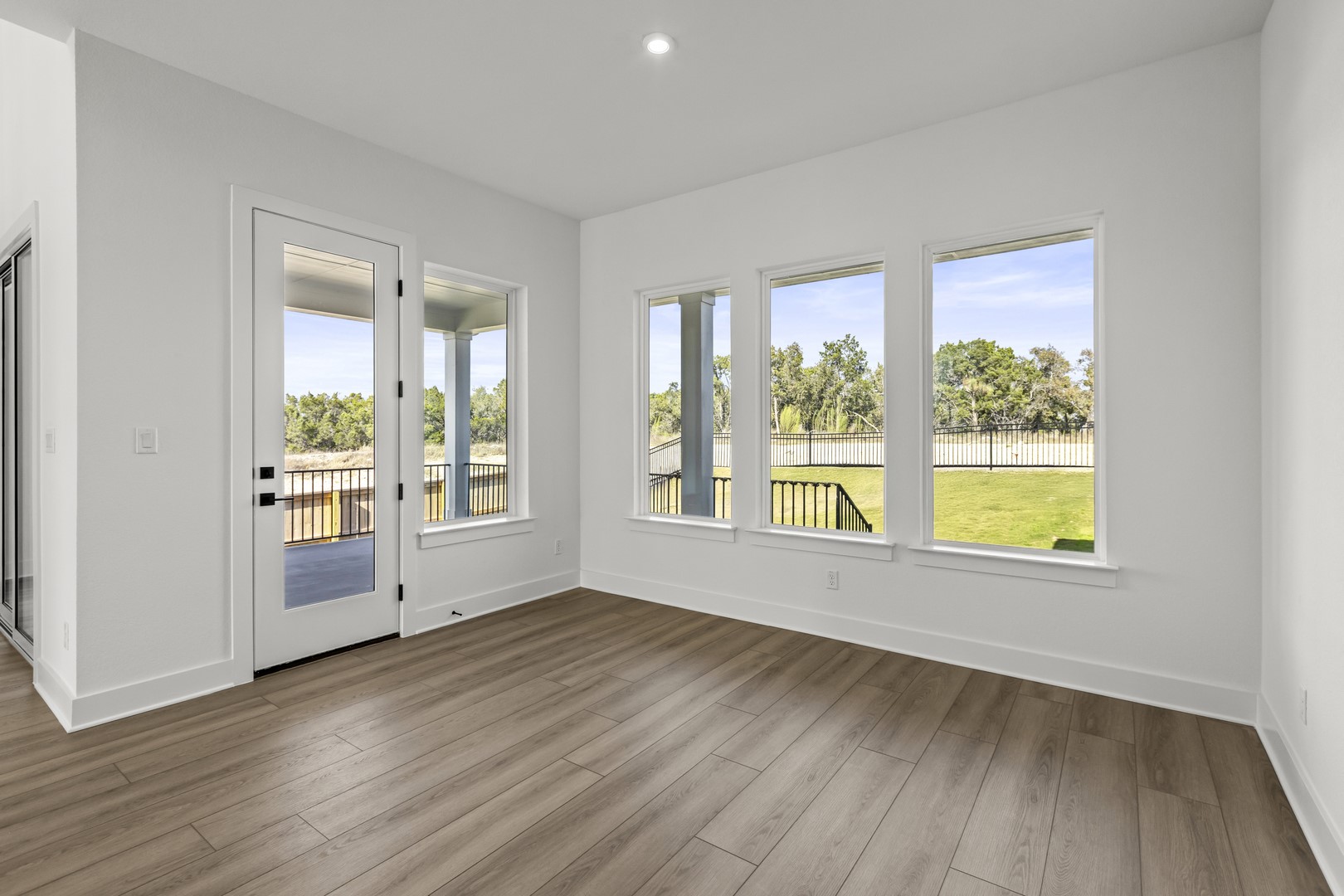 783 Iron Willow Loop Dripping Springs, TX 78620 - Photo 17 of 28 a view of an empty room with wooden floor and a window