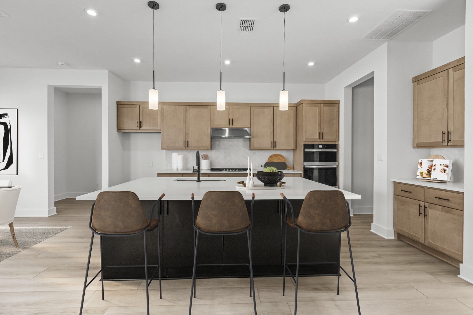 783 Iron Willow Loop Dripping Springs, TX 78620 - Photo 9 of 28 a kitchen with stainless steel appliances kitchen island granite countertop a dining table chairs and white cabinets