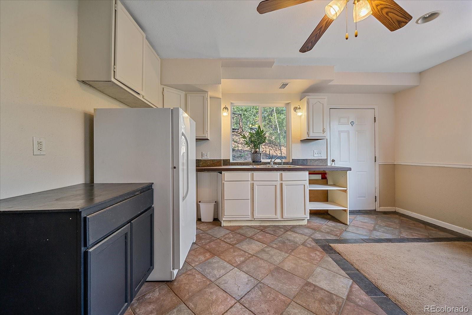 153 Wise Road Bailey, CO 80421 - Photo 20 of 38 a kitchen with a refrigerator sink and cabinets