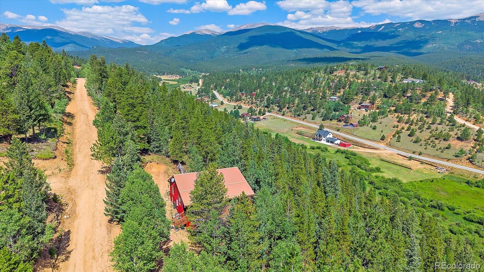 153 Wise Road Bailey, CO 80421 - Photo 2 of 38 a view of a green yard with an outdoor seating