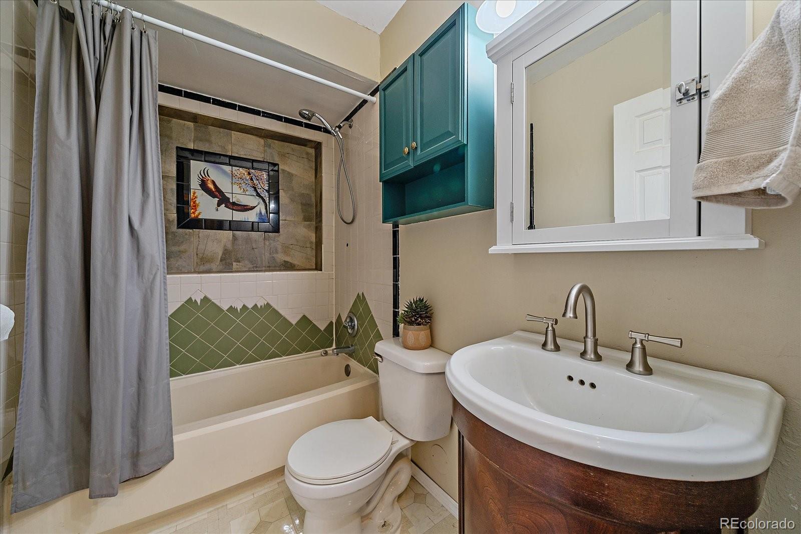 153 Wise Road Bailey, CO 80421 - Photo 23 of 38 a white toilet sitting next to a bathroom sink