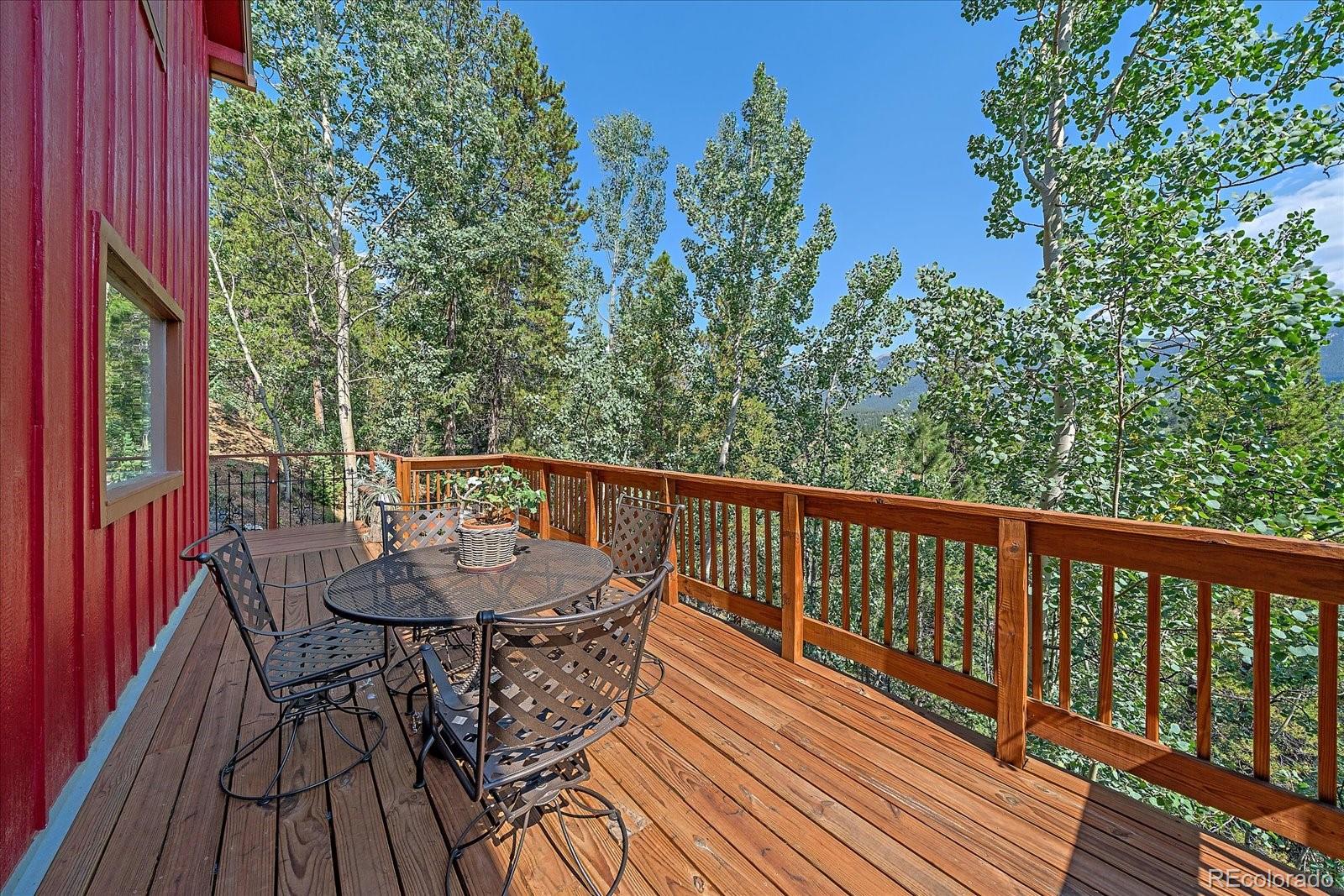 153 Wise Road Bailey, CO 80421 - Photo 26 of 38 a view of balcony with furniture and trees