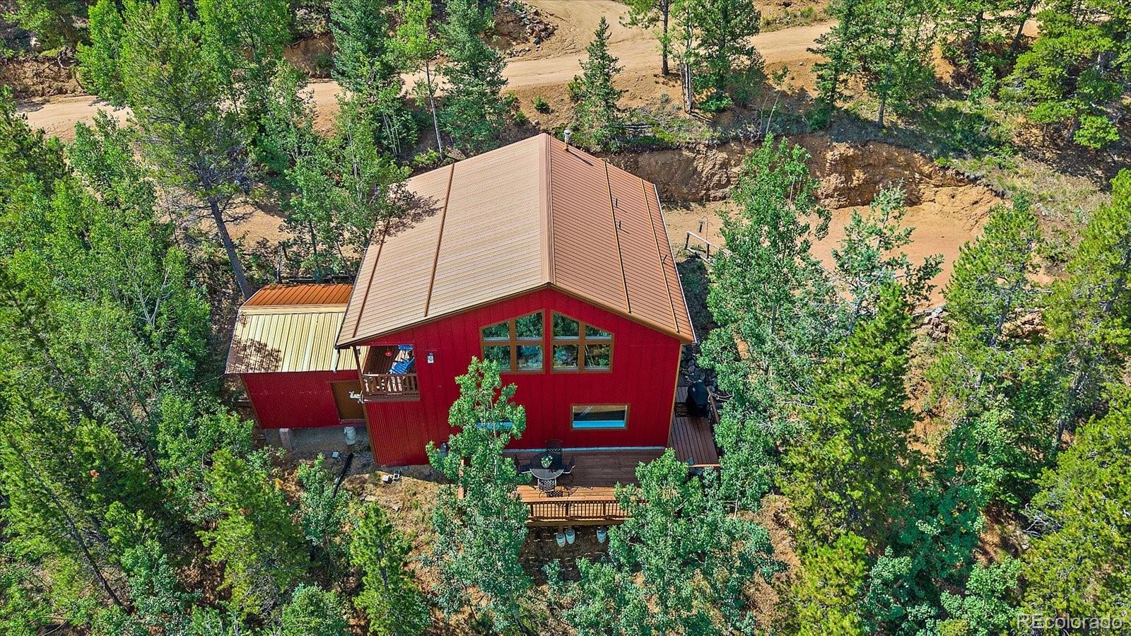 153 Wise Road Bailey, CO 80421 - Photo 30 of 38 an aerial view of a red and white house with a yard and a tree