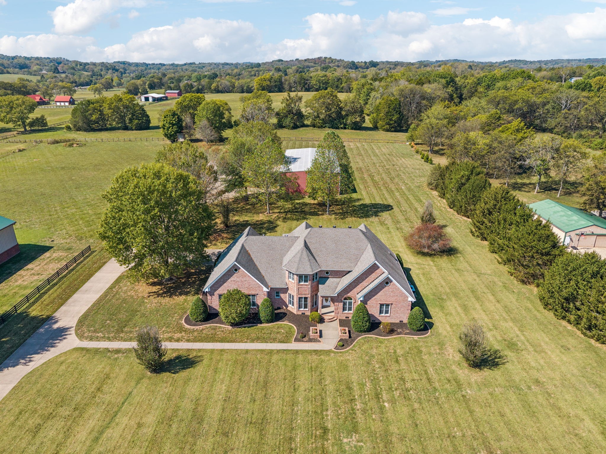 an aerial view of a house with swimming pool and lake view