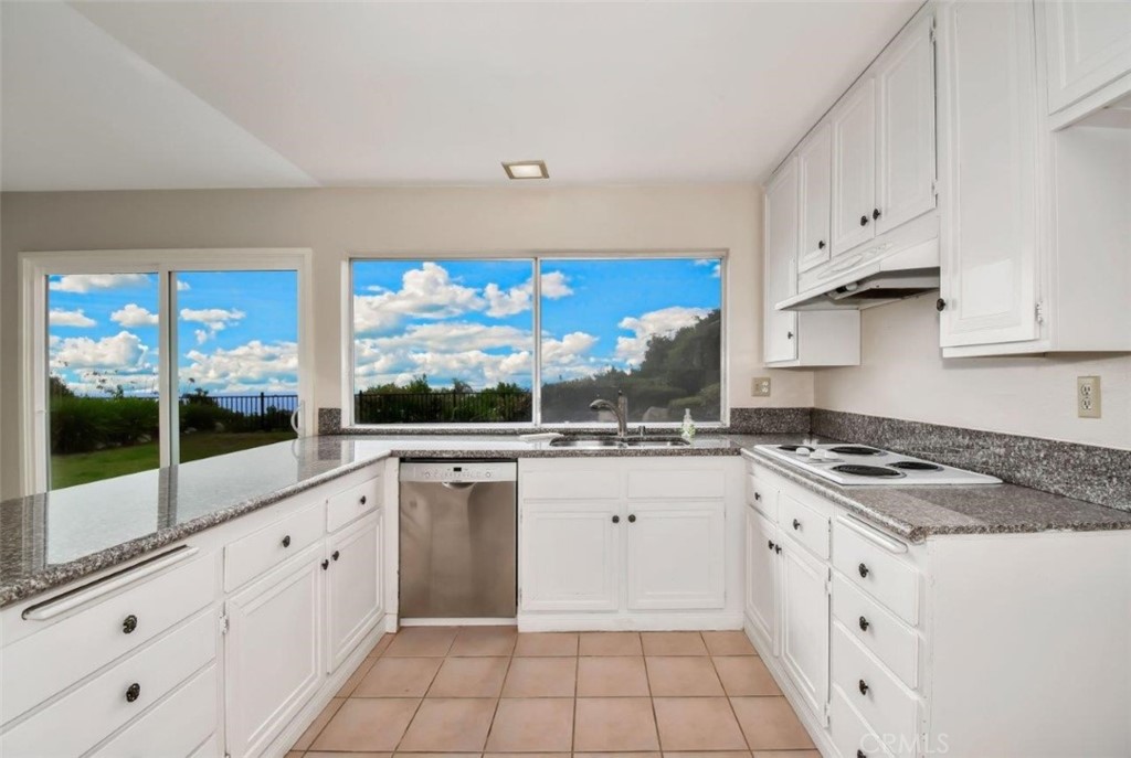 6803 Verde Ridge Road Rancho Palos Verdes, CA 90275 - Photo 11 of 26 a kitchen with white cabinets and white appliances