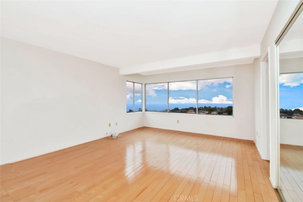 6803 Verde Ridge Road Rancho Palos Verdes, CA 90275 - Photo 16 of 26 a view of an empty room with wooden floor and a window
