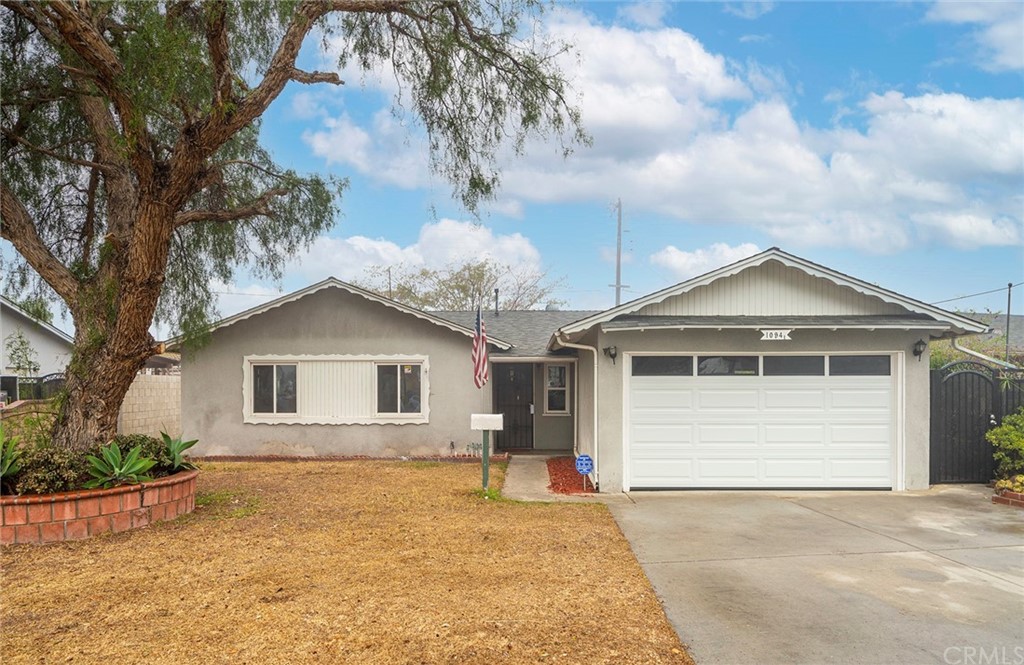 10941 Mac Street Anaheim, CA 92804 - Photo 2 of 41 a front view of a house with a yard and garage