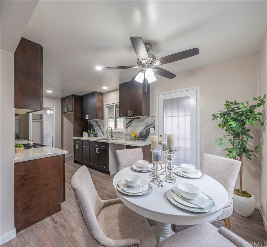 10941 Mac Street Anaheim, CA 92804 - Photo 11 of 41 a dining room with furniture a kitchen view and wooden floor