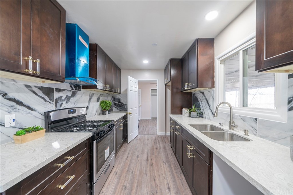 10941 Mac Street Anaheim, CA 92804 - Photo 12 of 41 a kitchen with stainless steel appliances granite countertop a sink a stove and a refrigerator