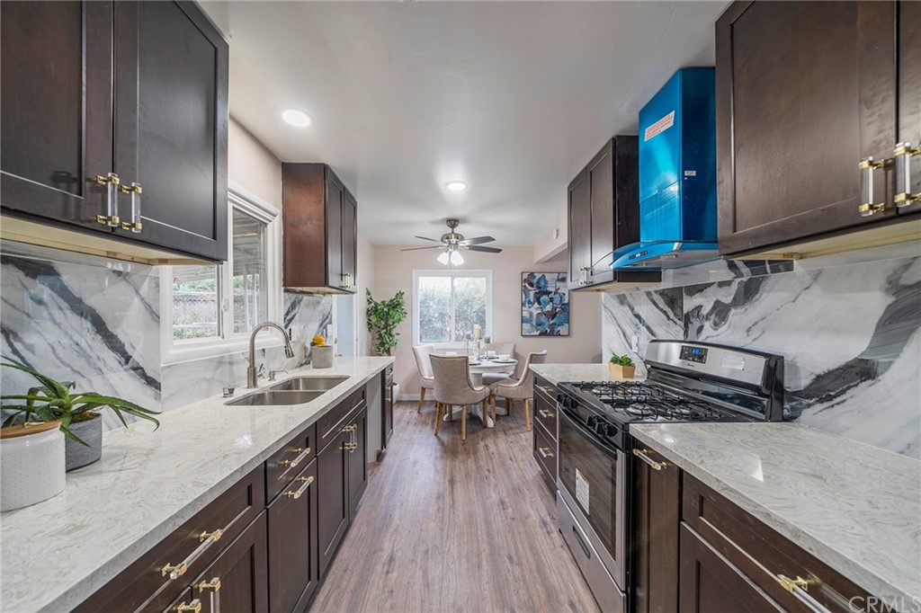 10941 Mac Street Anaheim, CA 92804 - Photo 15 of 41 a kitchen with stainless steel appliances granite countertop a sink stove and cabinets