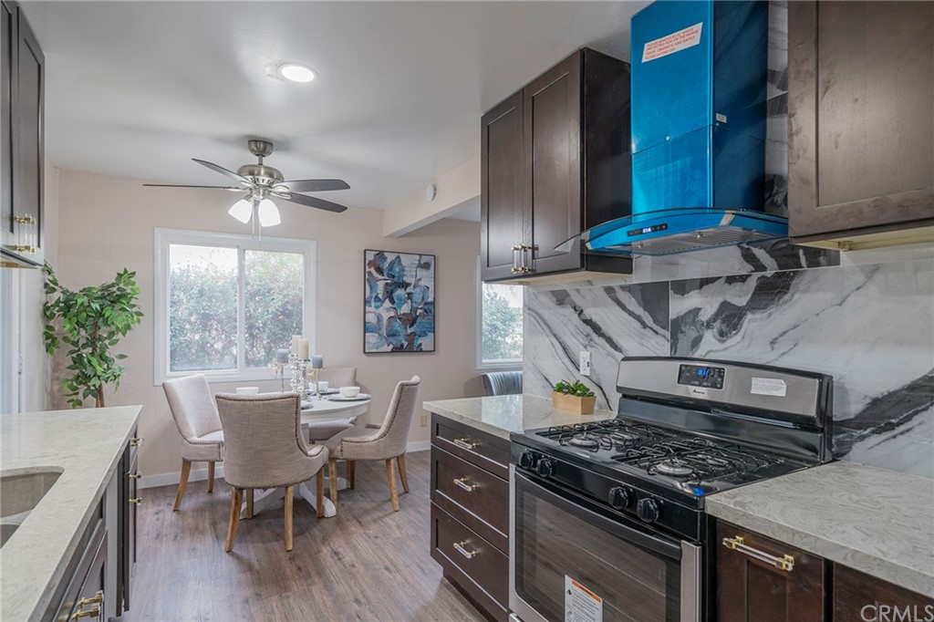 10941 Mac Street Anaheim, CA 92804 - Photo 17 of 41 a kitchen with stainless steel appliances granite countertop a stove a sink dishwasher and cabinets with wooden floor