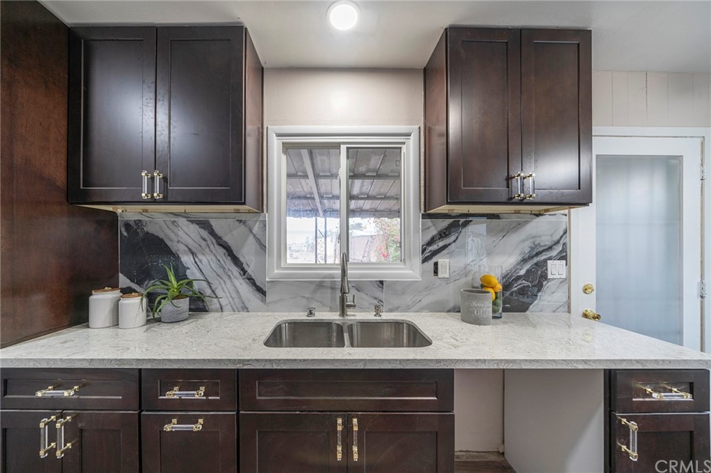 10941 Mac Street Anaheim, CA 92804 - Photo 18 of 41 a kitchen with a sink a counter space and cabinets