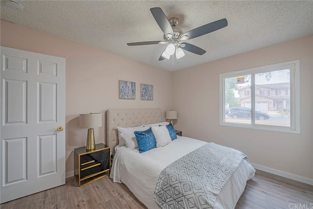 10941 Mac Street Anaheim, CA 92804 - Photo 30 of 41 a bedroom with a bed and a chandelier