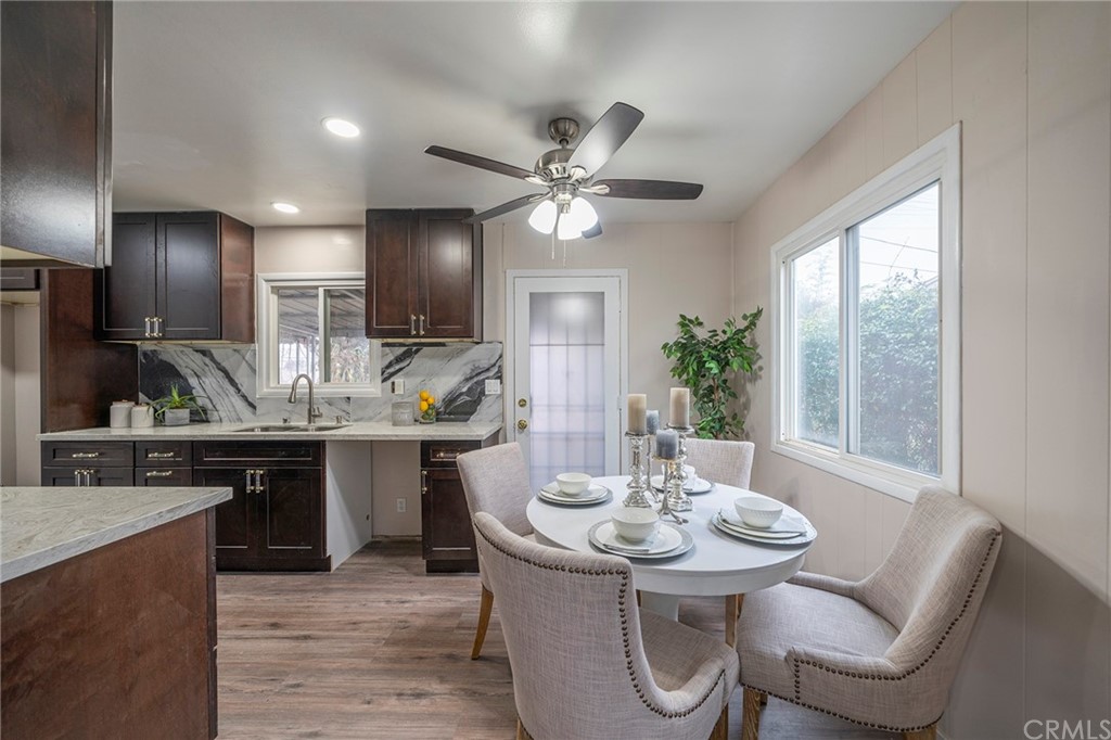 10941 Mac Street Anaheim, CA 92804 - Photo 8 of 41 a kitchen with a table chairs stove and refrigerator