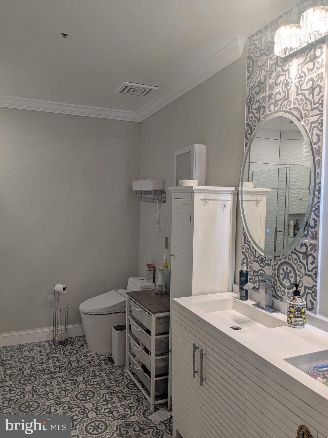 100 Harborview Drive, Unit 211 Baltimore, MD 21230 - Photo 6 of 25 a bathroom with a granite countertop sink mirror vanity and toilet