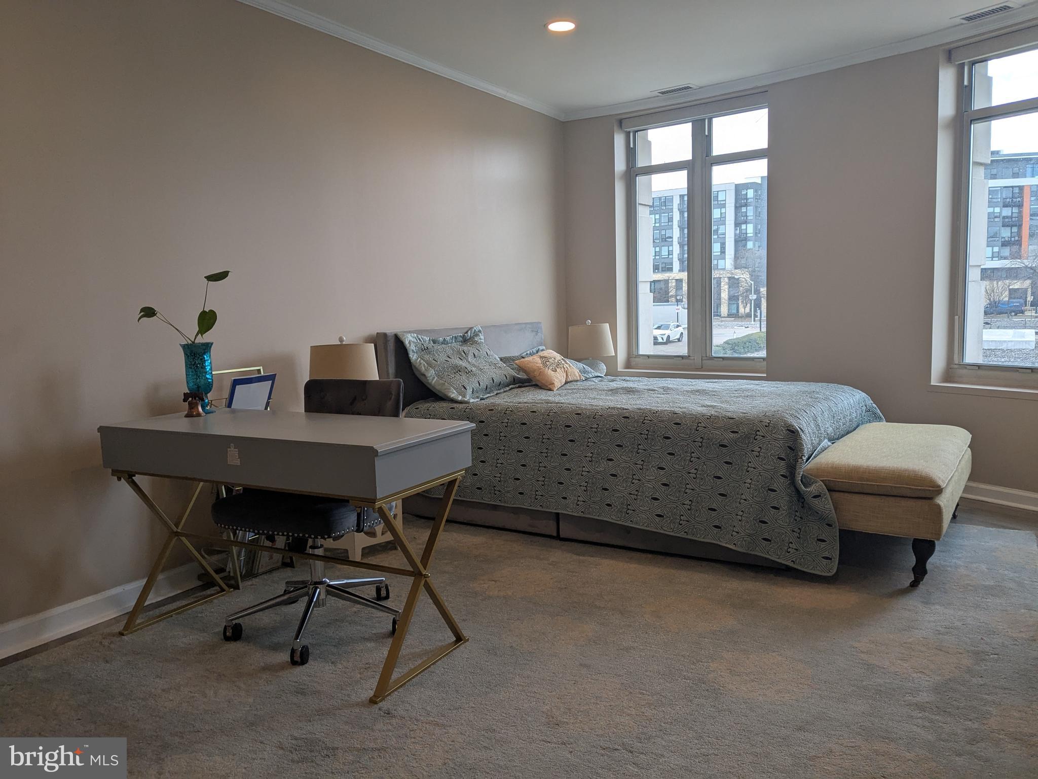 100 Harborview Drive, Unit 211 Baltimore, MD 21230 - Photo 7 of 25 a bedroom with a bed and a desk