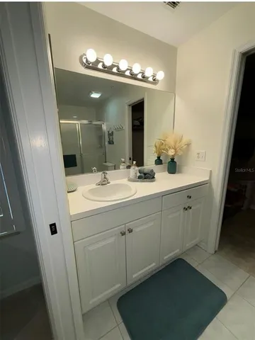 a bathroom with a double vanity sink and a mirror