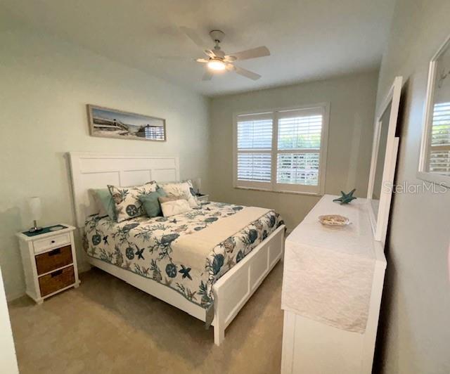 8369 Wingate Drive, Unit 2114 Sarasota, FL 34238 - Photo 15 of 26 a bedroom with a bed and a window