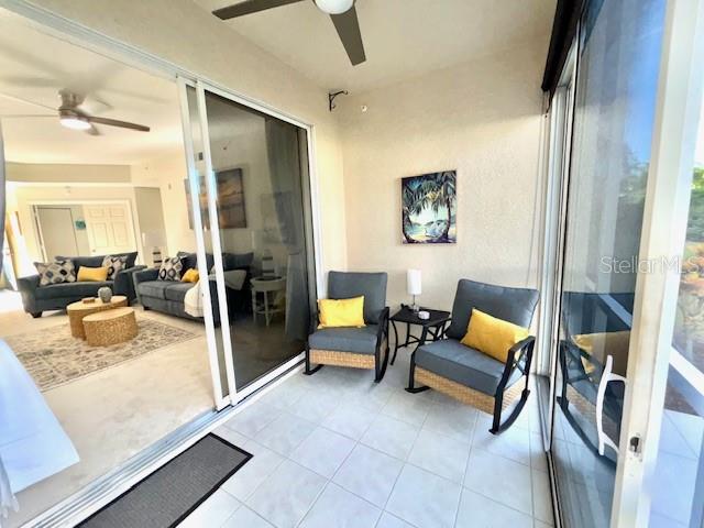 8369 Wingate Drive, Unit 2114 Sarasota, FL 34238 - Photo 21 of 26 a living room with furniture and a flat screen tv