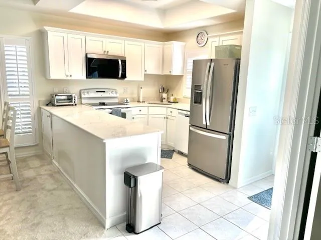 a kitchen with a refrigerator a microwave a sink and a stove