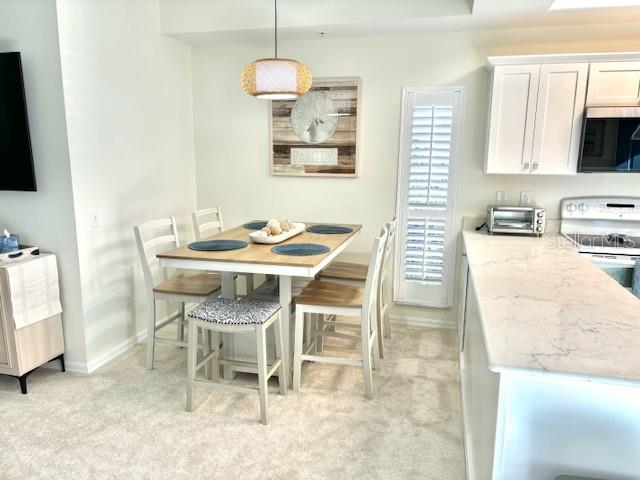 8369 Wingate Drive, Unit 2114 Sarasota, FL 34238 - Photo 6 of 26 a dining room with furniture and window